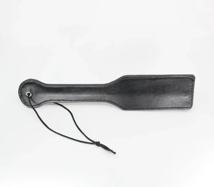 Our basic plain black faux leather paddle with nylon wrist strap.
